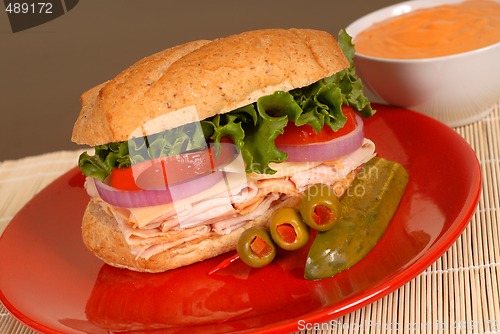 Image of Turkey and cheese sandwich with dipping sauce