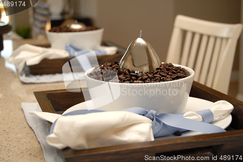 Image of Two dining place settings with coffee beans on a marble counter