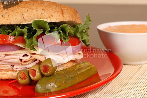Image of Turkey and swiss cheese sandwich with red pepper dipping sauce