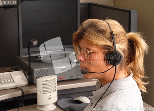 Image of Police dispatcher sitting at a dispatch console