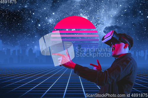 Image of Synth wave and retro wave, vaporwave futuristic aesthetics. Man with device in glowing neon style.