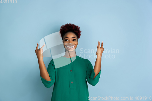 Image of Smiling girl with surreal huge smile and big mouth looks shocked, attracted, wondered and astonished. Copyspace for ad.