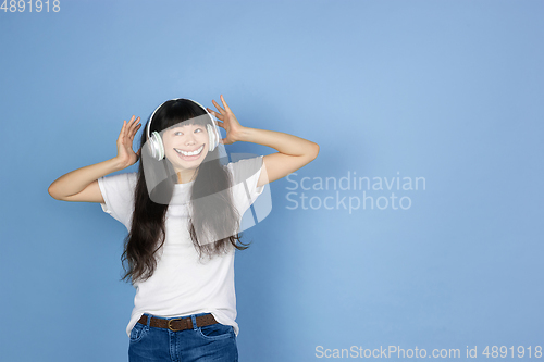 Image of Smiling girl with surreal huge smile and big mouth looks shocked, attracted, wondered and astonished. Copyspace for ad.