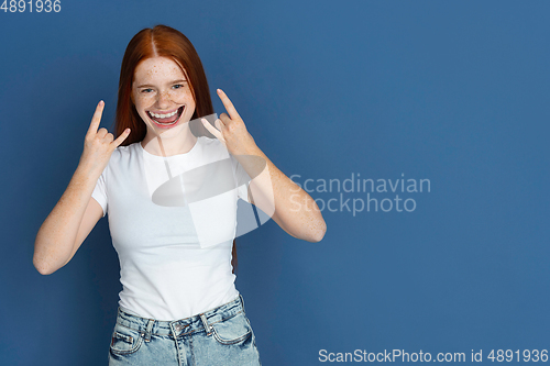Image of Smiling girl with surreal huge smile and big mouth looks shocked, attracted, wondered and astonished. Copyspace for ad.