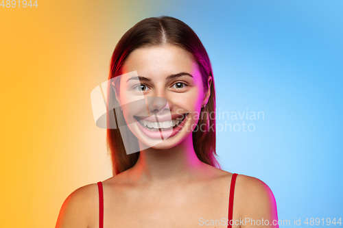 Image of Smiling girl with surreal huge smile and big mouth looks shocked, attracted, wondered and astonished. Copyspace for ad.