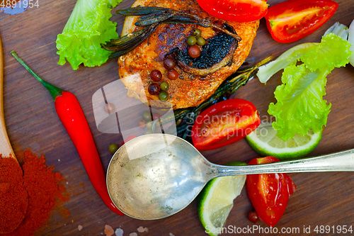 Image of wood fired hoven cooked chicken breast on wood board