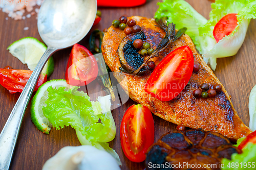 Image of wood fired hoven cooked chicken breast on wood board