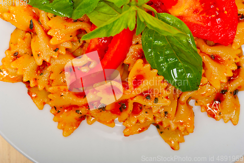 Image of Italian pasta farfalle butterfly bow-tie and tomato sauce