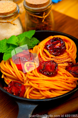 Image of italian spaghetti pasta and tomato with mint leaves