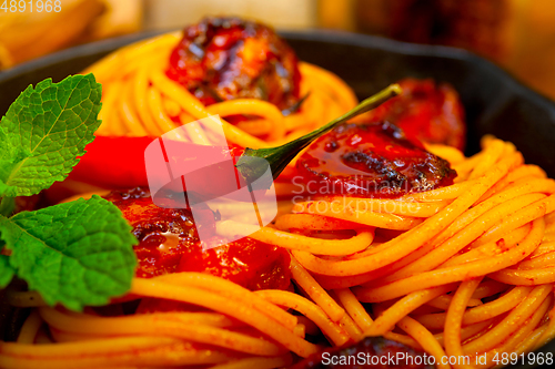 Image of italian spaghetti pasta and tomato with mint leaves