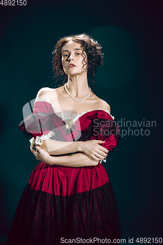 Image of Young woman as Anna Karenina on dark blue background. Retro style, comparison of eras concept.