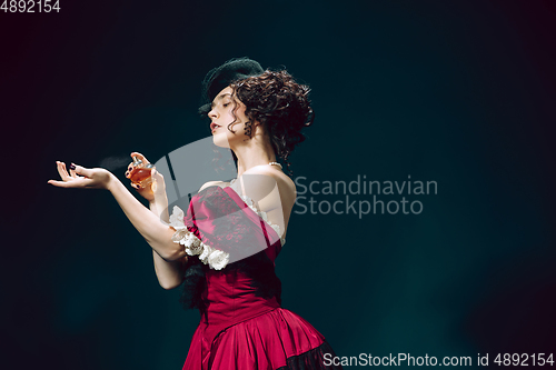 Image of Young woman as Anna Karenina on dark blue background. Retro style, comparison of eras concept.