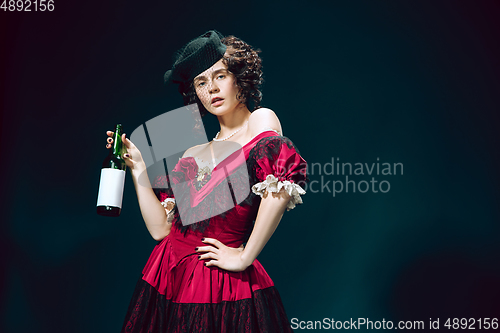 Image of Young woman as Anna Karenina on dark blue background. Retro style, comparison of eras concept.