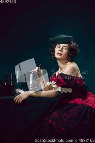 Image of Young woman as Anna Karenina on dark blue background. Retro style, comparison of eras concept.