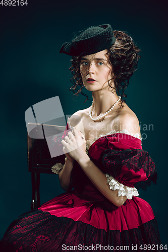 Image of Young woman as Anna Karenina on dark blue background. Retro style, comparison of eras concept.