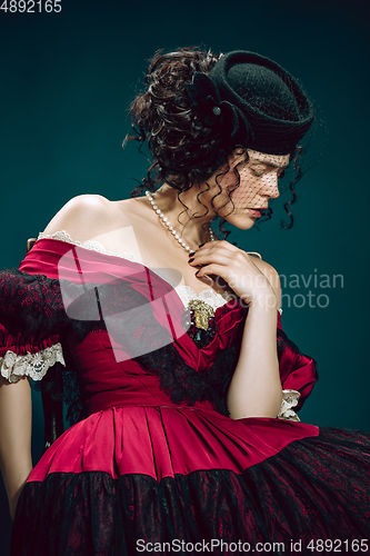 Image of Young woman as Anna Karenina on dark blue background. Retro style, comparison of eras concept.