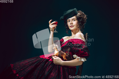 Image of Young woman as Anna Karenina on dark blue background. Retro style, comparison of eras concept.