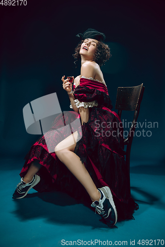 Image of Young woman as Anna Karenina on dark blue background. Retro style, comparison of eras concept.