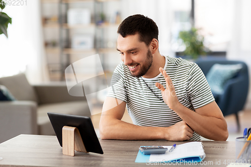 Image of man with tablet pc having video call at home