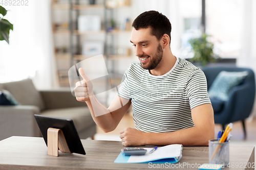 Image of man with tablet pc having video call at home