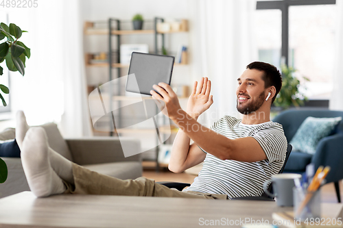 Image of man with tablet pc having video call at home