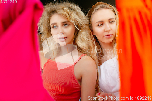 Image of Wear, clothing shop during sales, summer or autumn collection. Young women looking for new attire