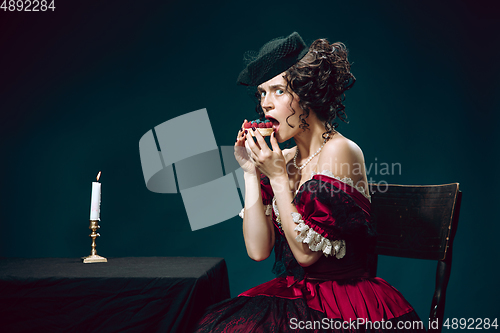 Image of Young woman as Anna Karenina on dark blue background. Retro style, comparison of eras concept.