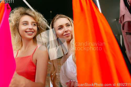 Image of Wear, clothing shop during sales, summer or autumn collection. Young women looking for new attire