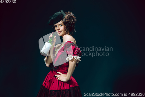 Image of Young woman as Anna Karenina on dark blue background. Retro style, comparison of eras concept.