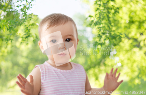 Image of portrait of little baby girl over nature