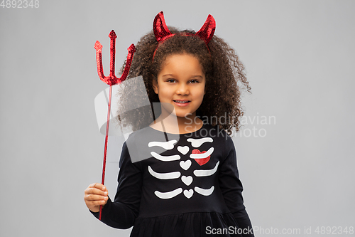 Image of girl with trident and devil's horns on halloween