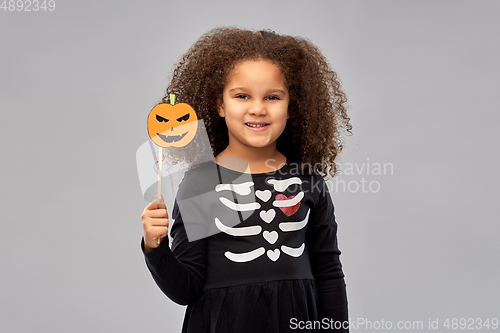 Image of girl in halloween costume with jack-o-lantern