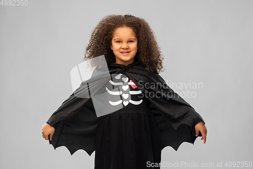 Image of girl in costume of dracula with cape on halloween