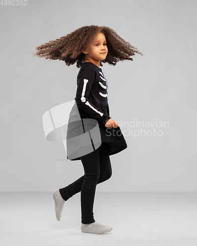 Image of girl in black halloween dress with skeleton bones