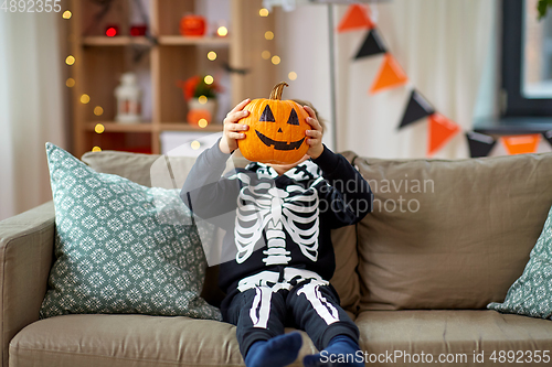 Image of boy in halloween costume with jack-o-lantern