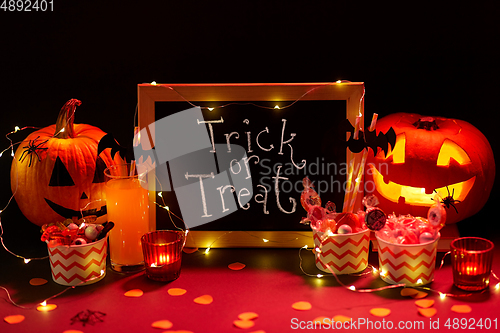 Image of pumpkins, candies and halloween decorations