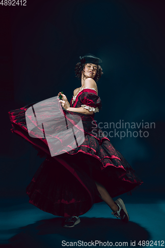 Image of Young woman as Anna Karenina on dark blue background. Retro style, comparison of eras concept.