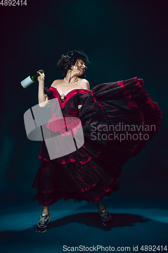 Image of Young woman as Anna Karenina on dark blue background. Retro style, comparison of eras concept.