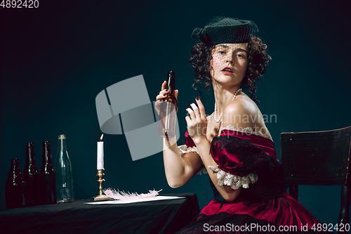 Image of Young woman as Anna Karenina on dark blue background. Retro style, comparison of eras concept.