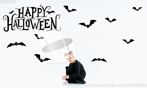 Image of Little girl as vampire on white background, halloween time, flyer with copyspace