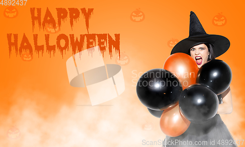 Image of Young woman a witch on scary background