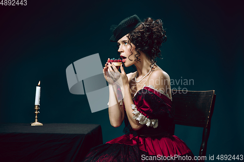 Image of Young woman as Anna Karenina on dark blue background. Retro style, comparison of eras concept.