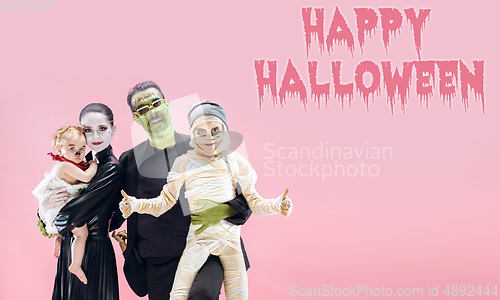 Image of Young family as zombies on pink background, halloween time, flyer with copyspace