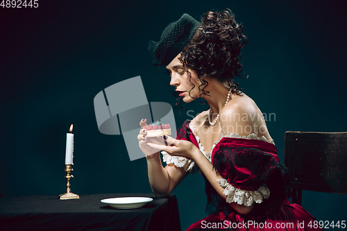 Image of Young woman as Anna Karenina on dark blue background. Retro style, comparison of eras concept.