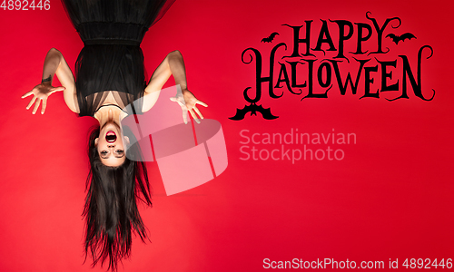 Image of Young woman a witch on scary background