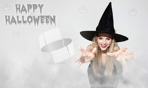 Image of Young woman a witch on scary background