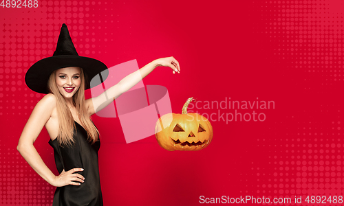 Image of Young woman a witch on scary background
