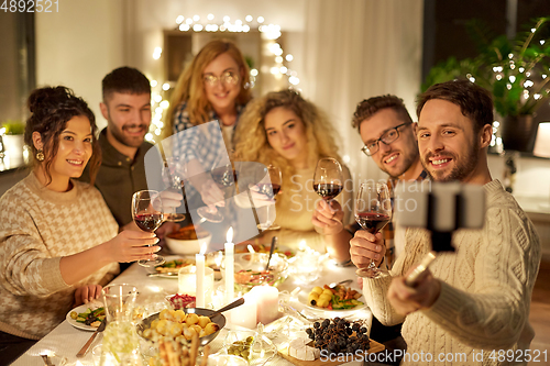 Image of friends taking selfie at christmas dinner party