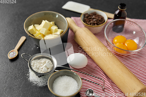 Image of rolling pin, butter, eggs, flour and chocolate