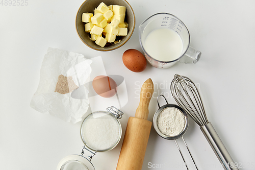 Image of rolling pin, butter, eggs, flour, milk and sugar